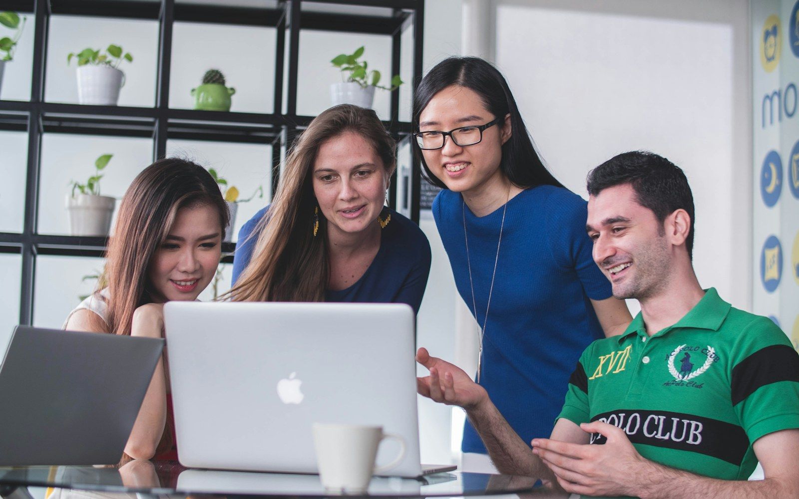 A development team discussing a website at a laptop