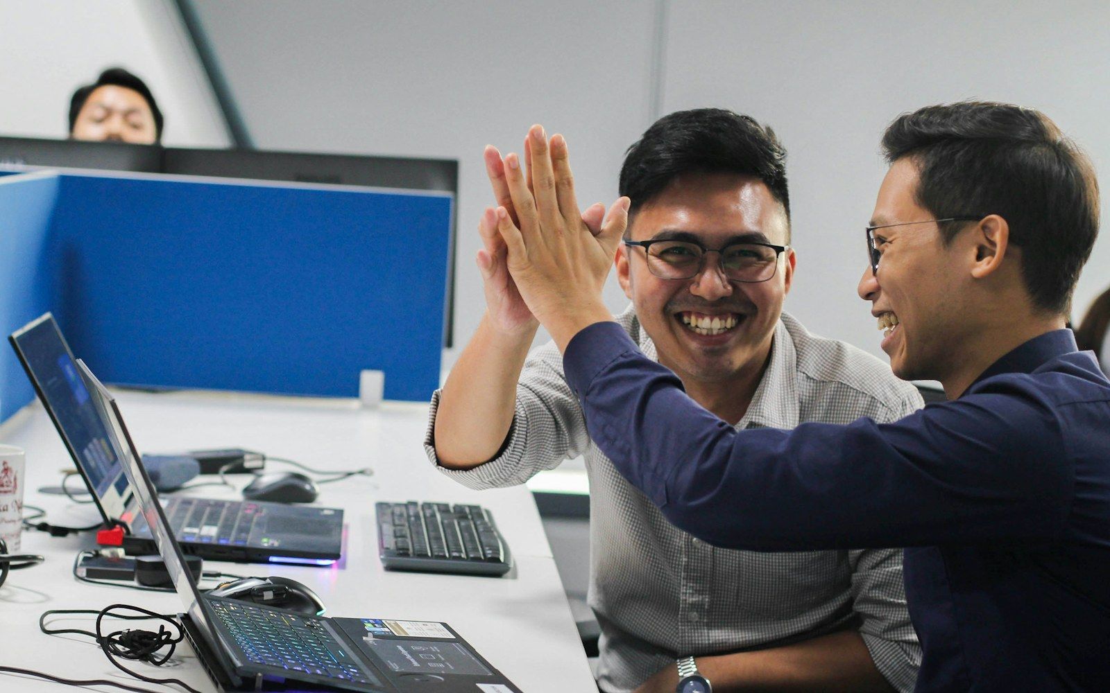 Developers celebrating a result at their desks